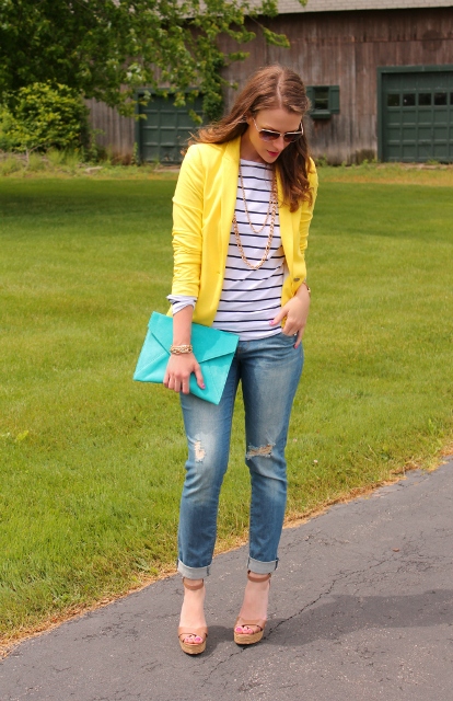 With distressed jeans, striped shirt, sandals and clutch