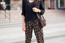 With floral jumpsuit, black shirt and brown bag