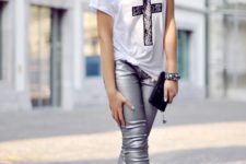 With graphic shirt, black pumps and mini clutch