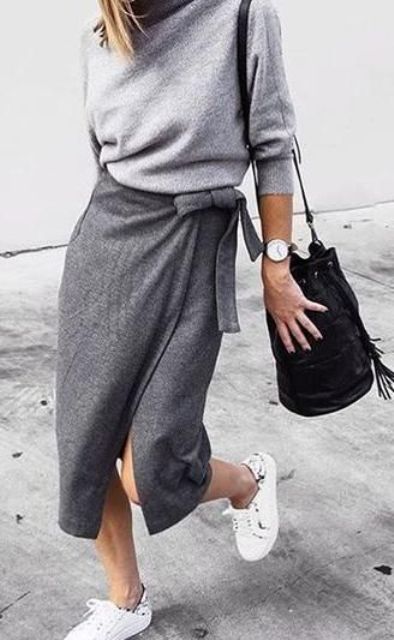 With gray sweater, white sneakers and black bag