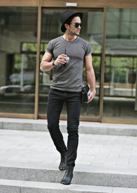 With gray t-shirt, black hat and ankle boots
