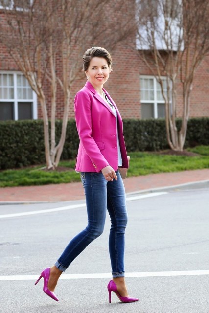 With hot pink blazer and cuffed jeans