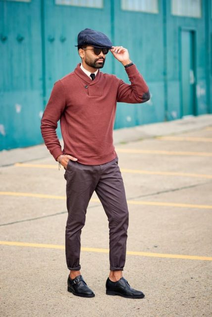 With navy blue cap, sweater and cuffed pants