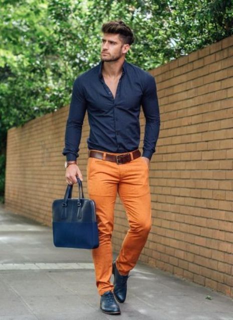With navy blue shirt, boots and leather bag