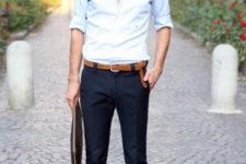 With navy blue trousers, white shirt and leather belt