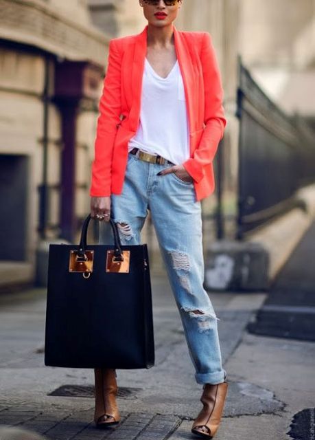 With orange blazer, loose t-shirt, distressed jeans and big bag