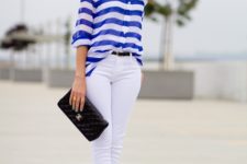 With striped loose blouse, white pants and black clutch