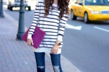 With striped loose sweater, distressed jeans and pink clutch