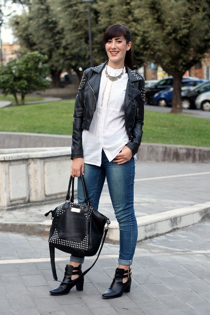 With white blouse, leather jacket, cuffed jeans and bag
