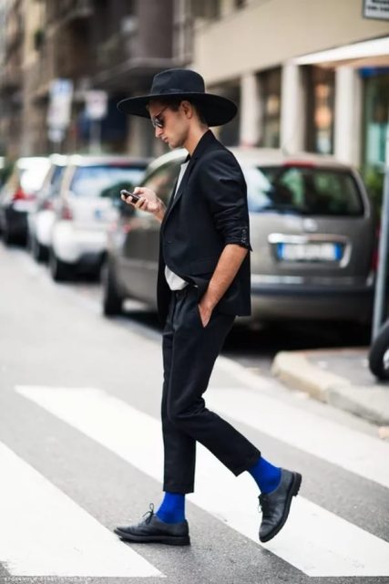 With white shirt, black blazer, blue socks, shoes and wide brim hat