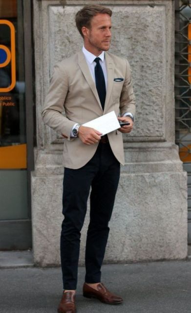 With white shirt, dark color tie, beige blazer and brown loafers