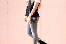 With white t-shirt, black top, gray pants and small bag