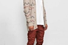 With white t-shirt, geometric printed jacket, gray hat and black shoes