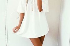 simple white mini dress with short sleeves and lace up sandals for a boho look