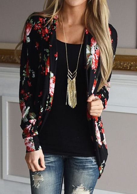 distressed jeans, a black top and a black floral blazer