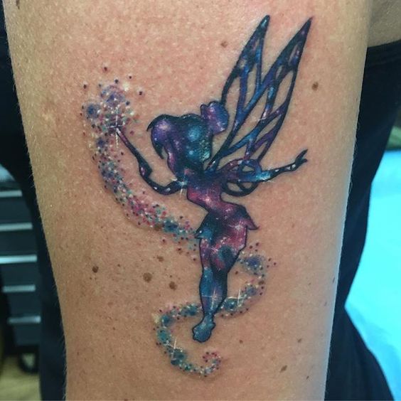 a colorful fairy tattoo with magical dust