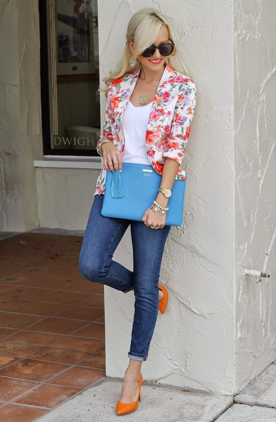 blue jeans, a white top, a bold floral blazer and orange heels