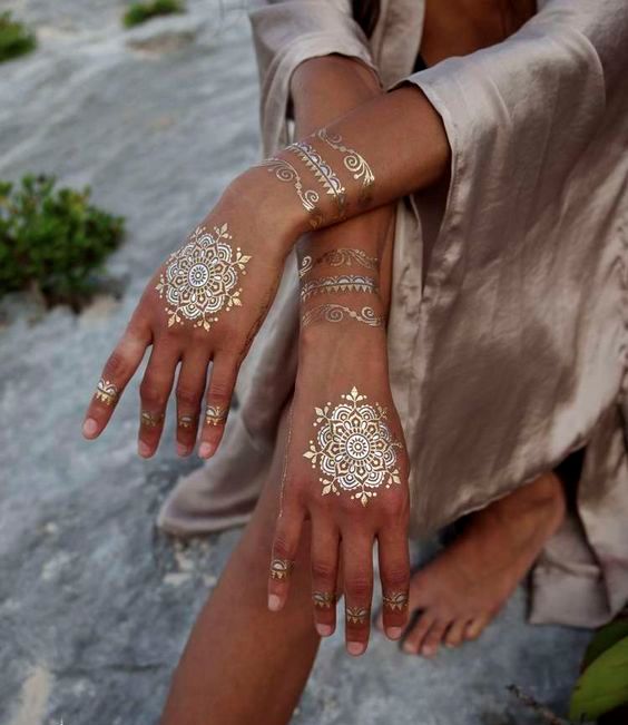 stunning gold henna tattoos on the hands, wrists and fingers