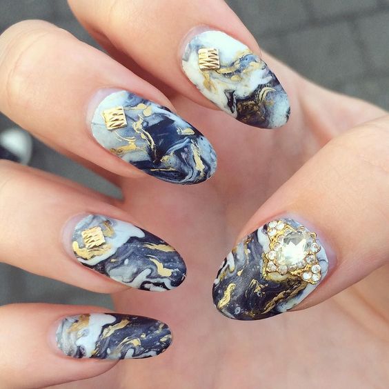black marble nails with gold accents and textural details