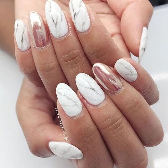 marble nails with an accent metallic pink one