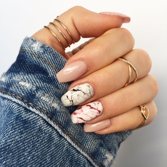 nude nails and two accent marble ones in black and red
