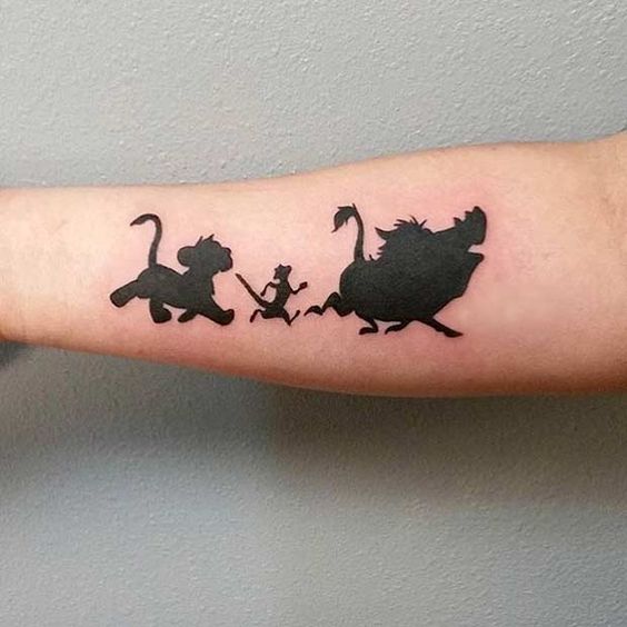 black ink Timon and Pumba tattoo on an arm