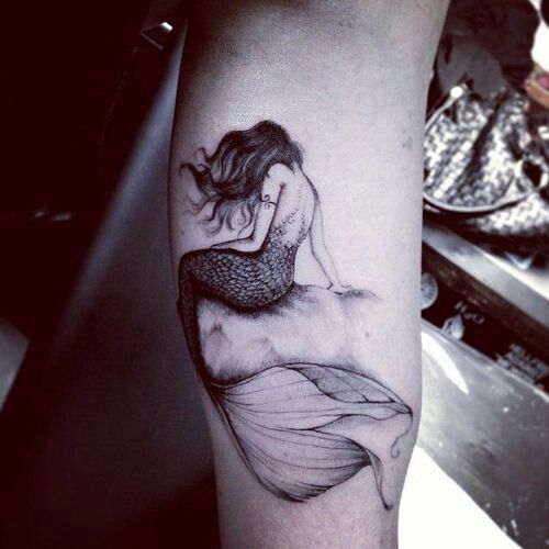 cool mermaid tattoo on an arm looks very romantic