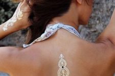 19 gold Indian-inspired back tattoo