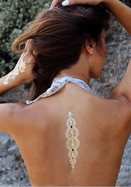 gold Indian-inspired back tattoo