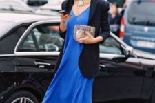 With black blazer, golden necklace and clutch