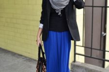 With black shirt, black jacket, gray scarf and leopard bag