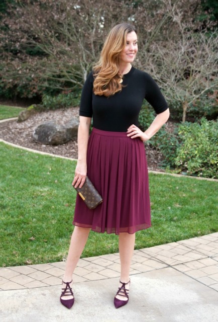 With black shirt, marsala shoes and printed clutch