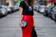 With black t-shirt, white sneakers and printed clutch