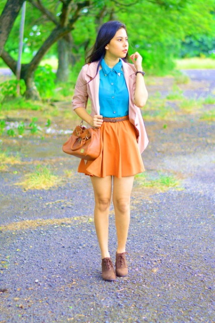 With blue shirt, pale pink blazer, ankle boots and brown bag