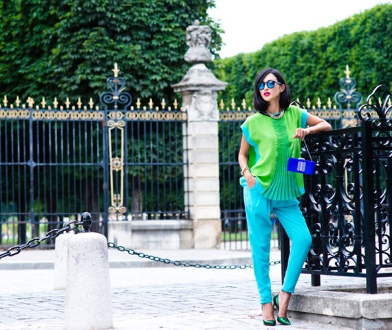 With green loose blouse, turquoise pants and cobalt blue clutch