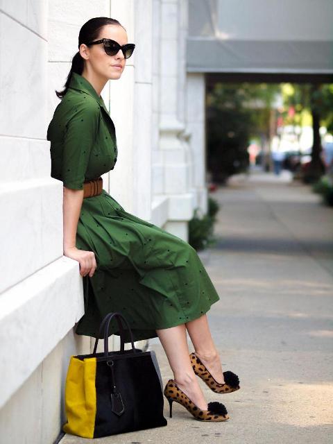 With green midi dress and yellow and black bag