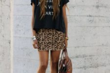 With loose black t-shirt, brown bag and ankle boots