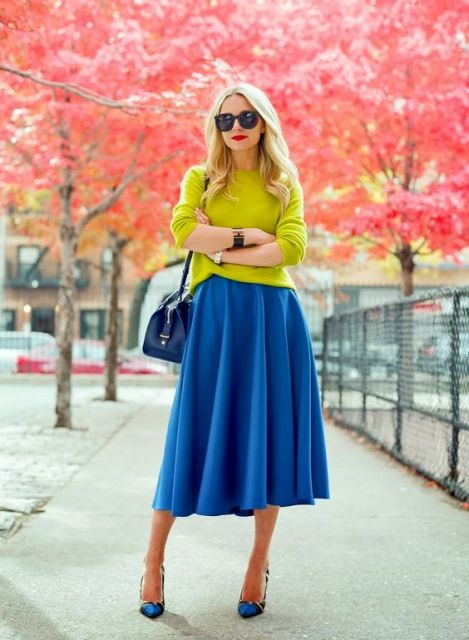 With neon green shirt, printed shoes and blue bag