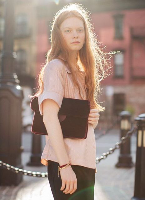 With pale pink blouse and black skirt