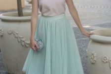 With pale pink silk top, silver shoes and mini clutch