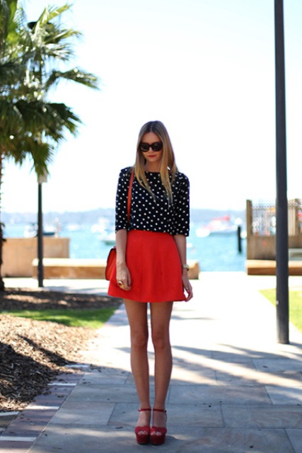 With polka dot blouse, red bag and red sandals