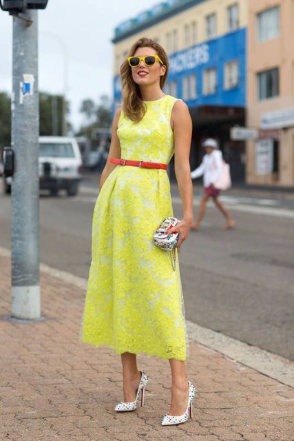With red belt, printed mini clutch and polka dot shoes