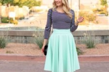 With striped shirt, mint green sandals and black bag