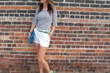 With striped shirt, white shorts, green belt and blue clutch
