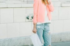 With white shirt, distressed jeans, sandals and white clutch