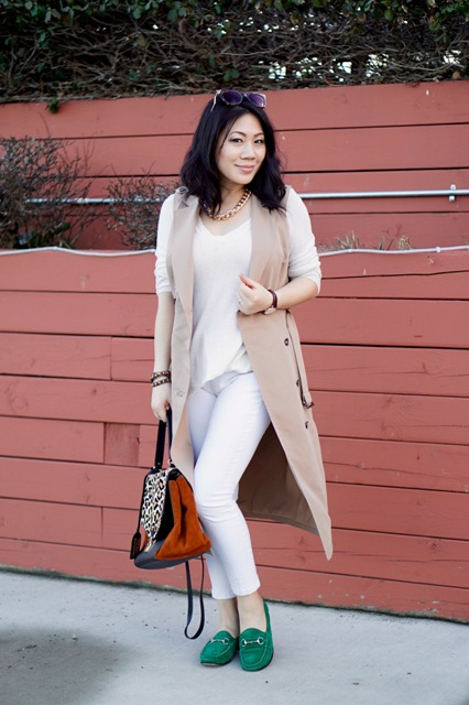 With white shirt, white skinny pants, camel long vest and printed bag