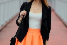 With white top, black blazer, black tights and small bag
