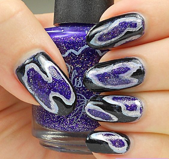 bold geode-inspired manicure in black and purple