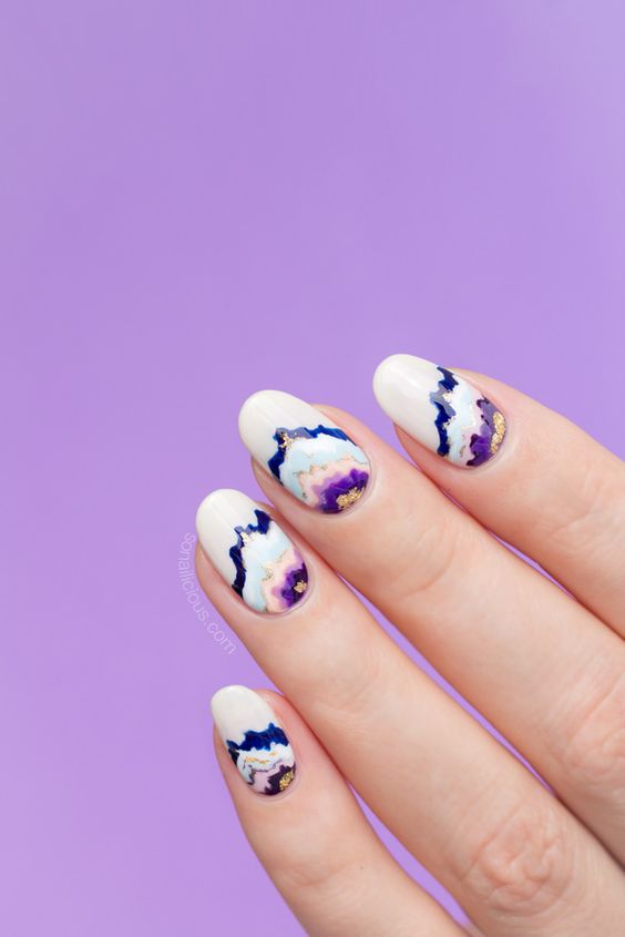 geode inspired nails in white, purple and blue