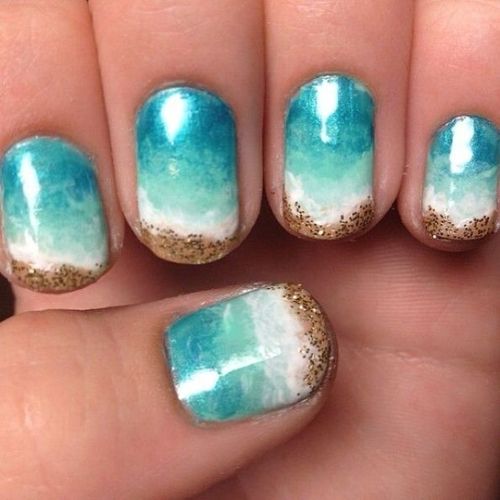 ombre turquoise nails from blue to white and sand-inspired glitter decor